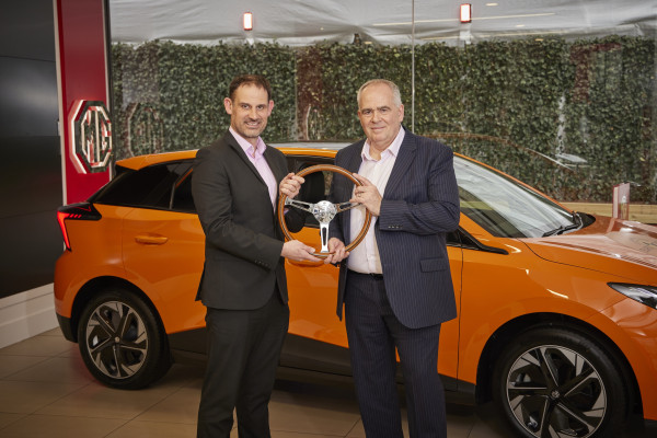 Guy Pigounakis (right), commercial director, MG UK, is presented with the UK Car of the Year 2023 trophy by John Challen (left), director of the UK Car of the Year Awards
