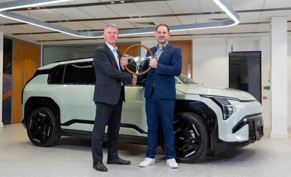 Paul Philpott (left), president and CEO, Kia UK, is presented with the UK Car of the Year 2025 trophy by John Challen (right), director, UK Car of the Year Awards